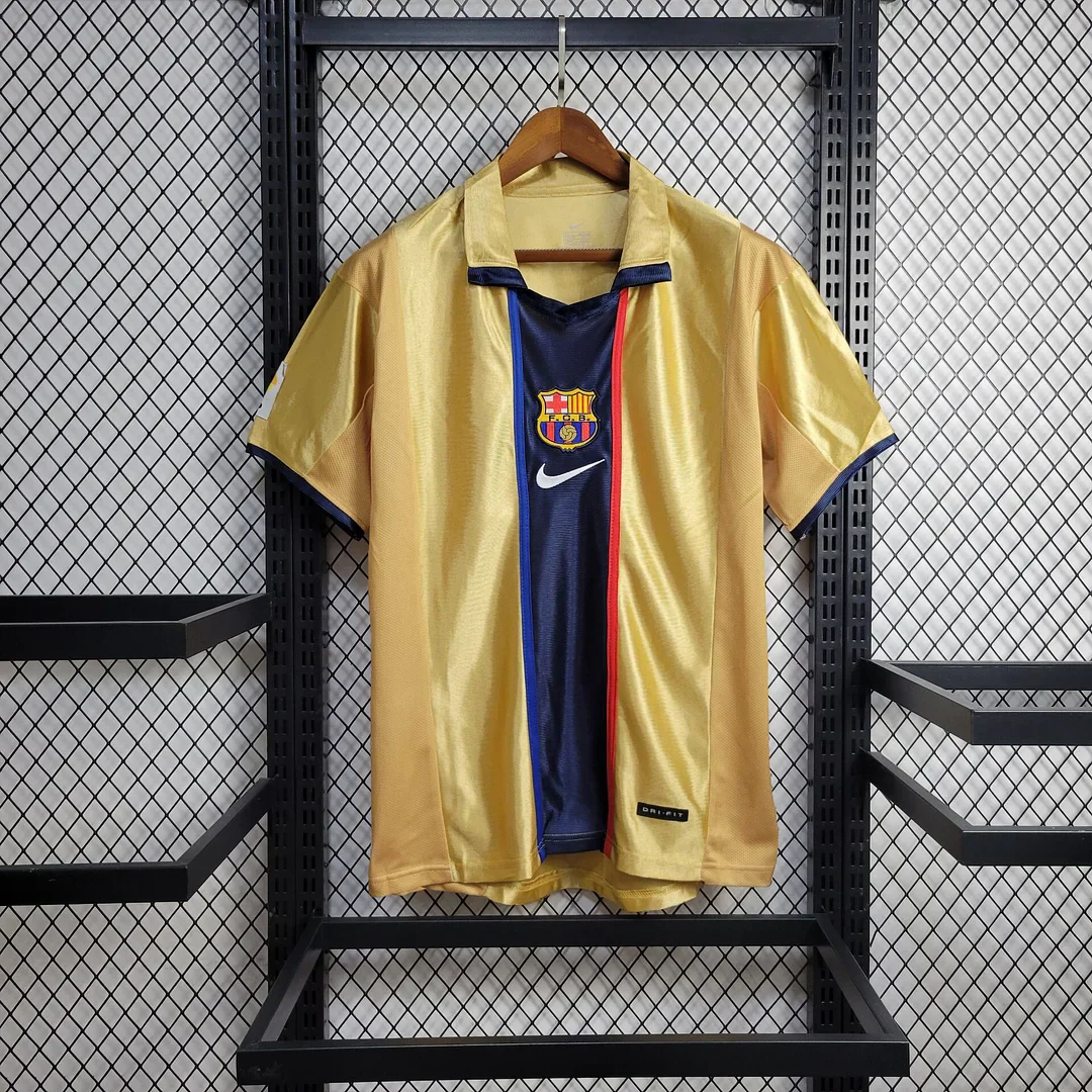 2001/02-labelled gold Barcelona shirt with a central navy stripe edged in red