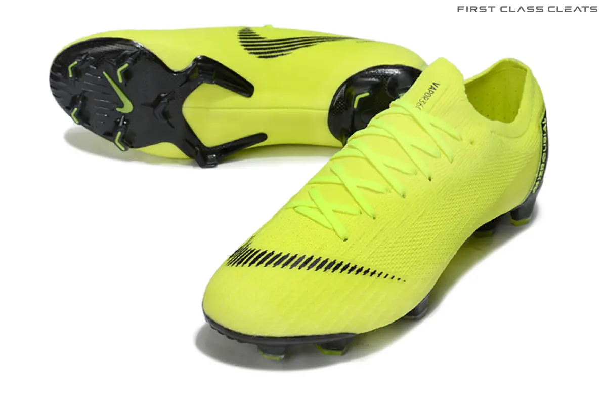 Angled pair of neon yellow Mercurial Vapor 12 football boots showing matching laces, a black striped swoosh across the toe and black forefoot and heel sole sections.