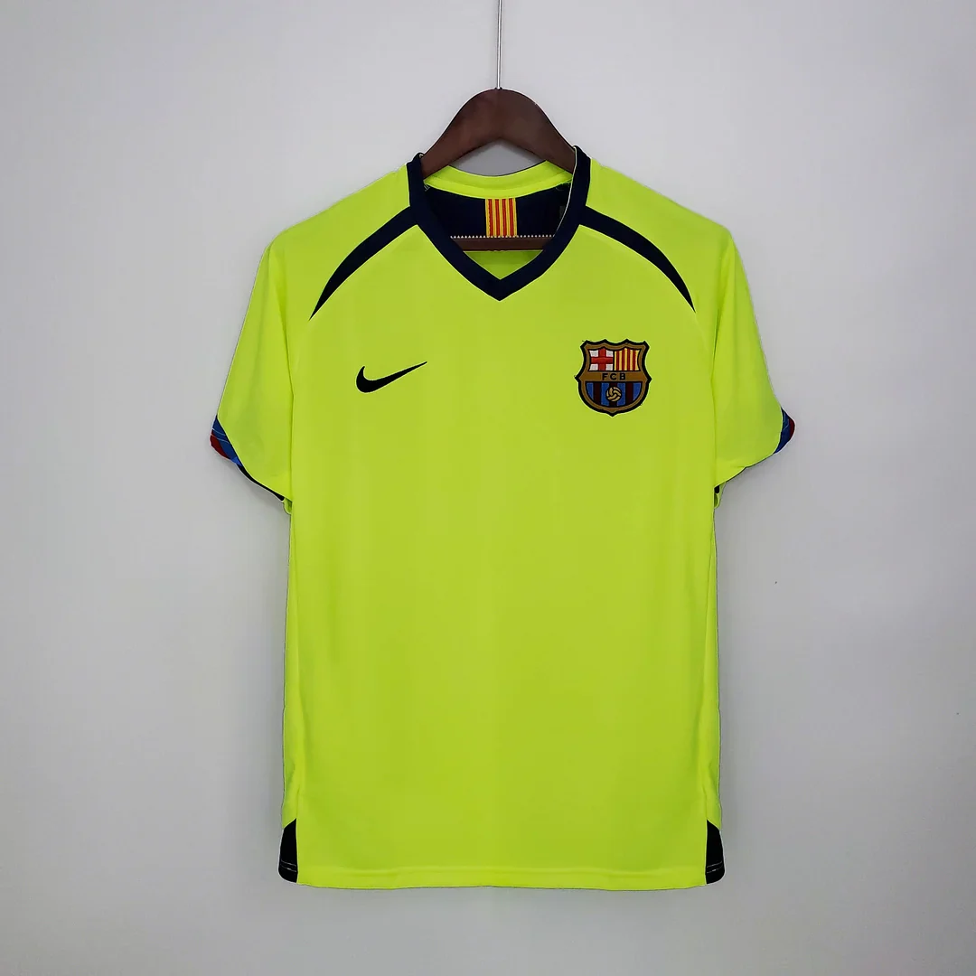 2005/06-labelled neon yellow Barcelona away shirt with a navy V-shaped neckline