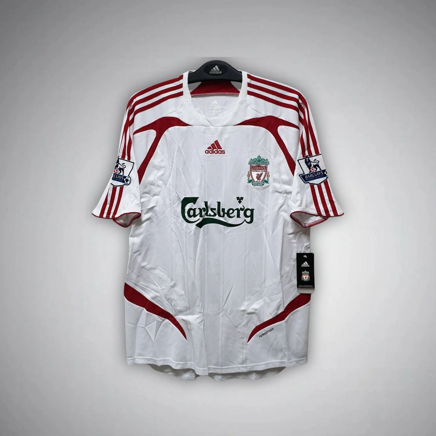 2007–2008 Liverpool away shirt with white body, red shoulder stripes and curved red panels