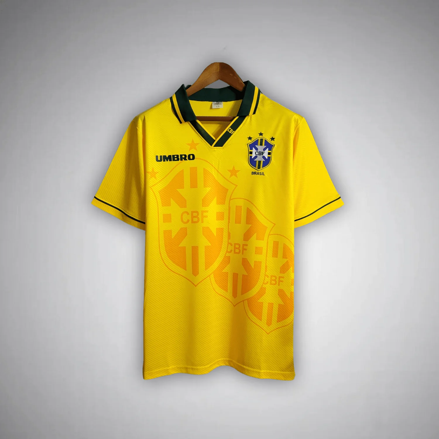 1994 Brazil home shirt with green V-neck and large pale orange CBF shield graphics on yellow