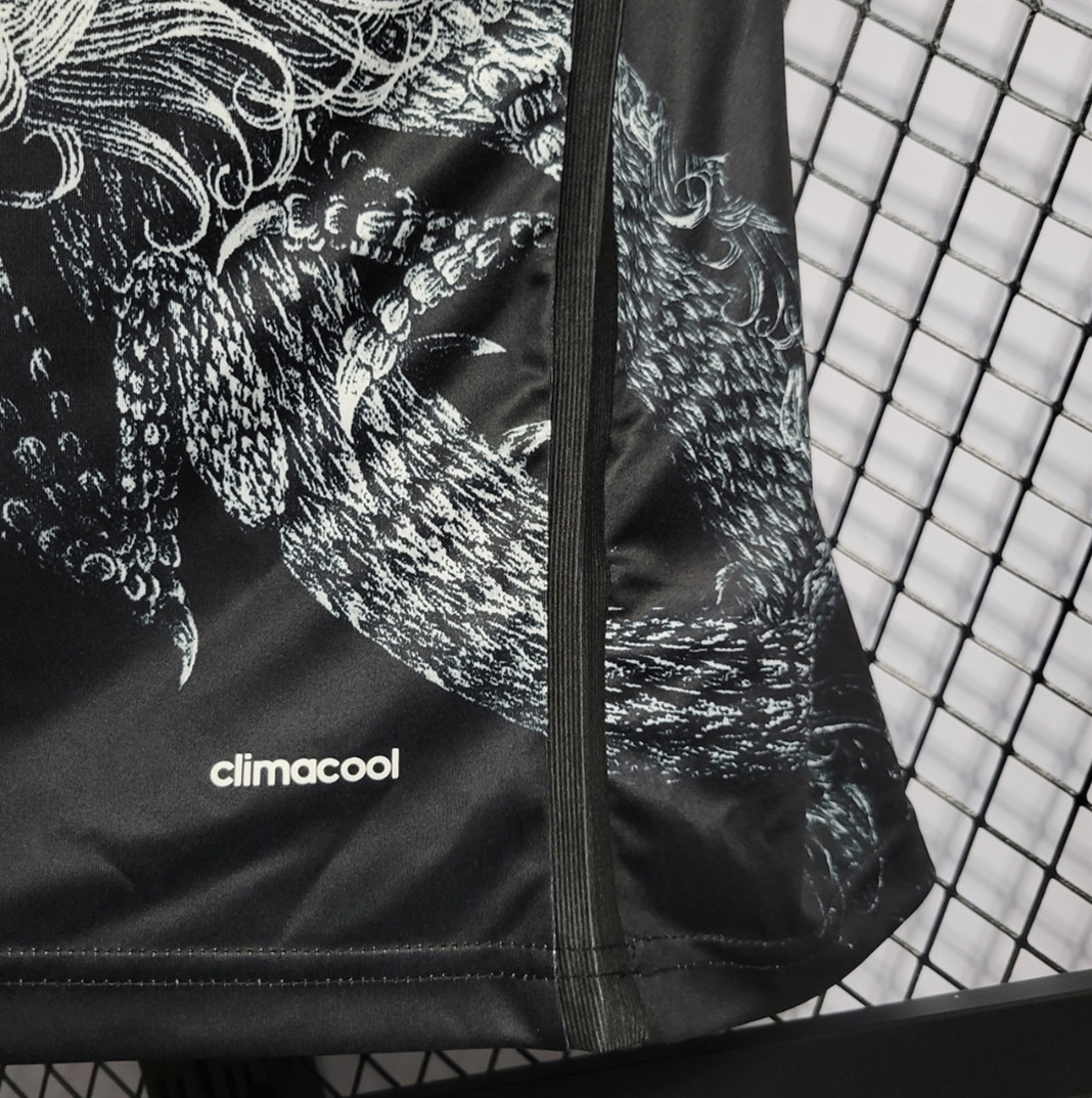 Real Madrid black dragon football shirt lower detail with pale dragon artwork, white climacool lettering and a stitched side seam