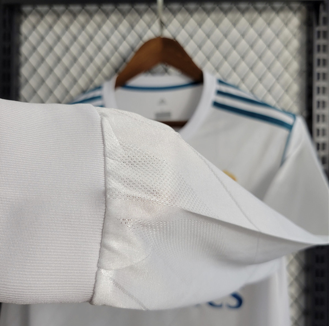 Real Madrid white long sleeve football shirt cuff close-up showing the broad white ribbed cuff and adjoining sleeve seam