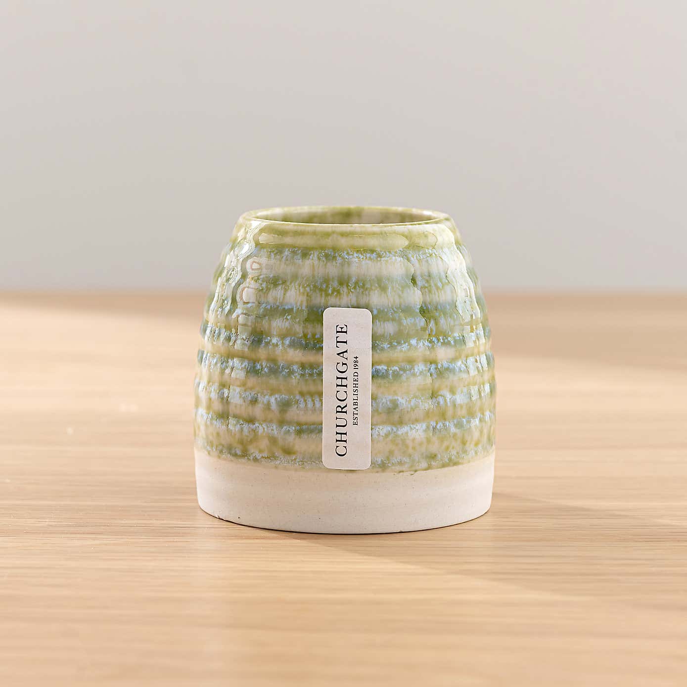 White Rose & Eucalyptus Floral Arrangement in Ribbed Glass Vase with Soft Amber & Pine Candle