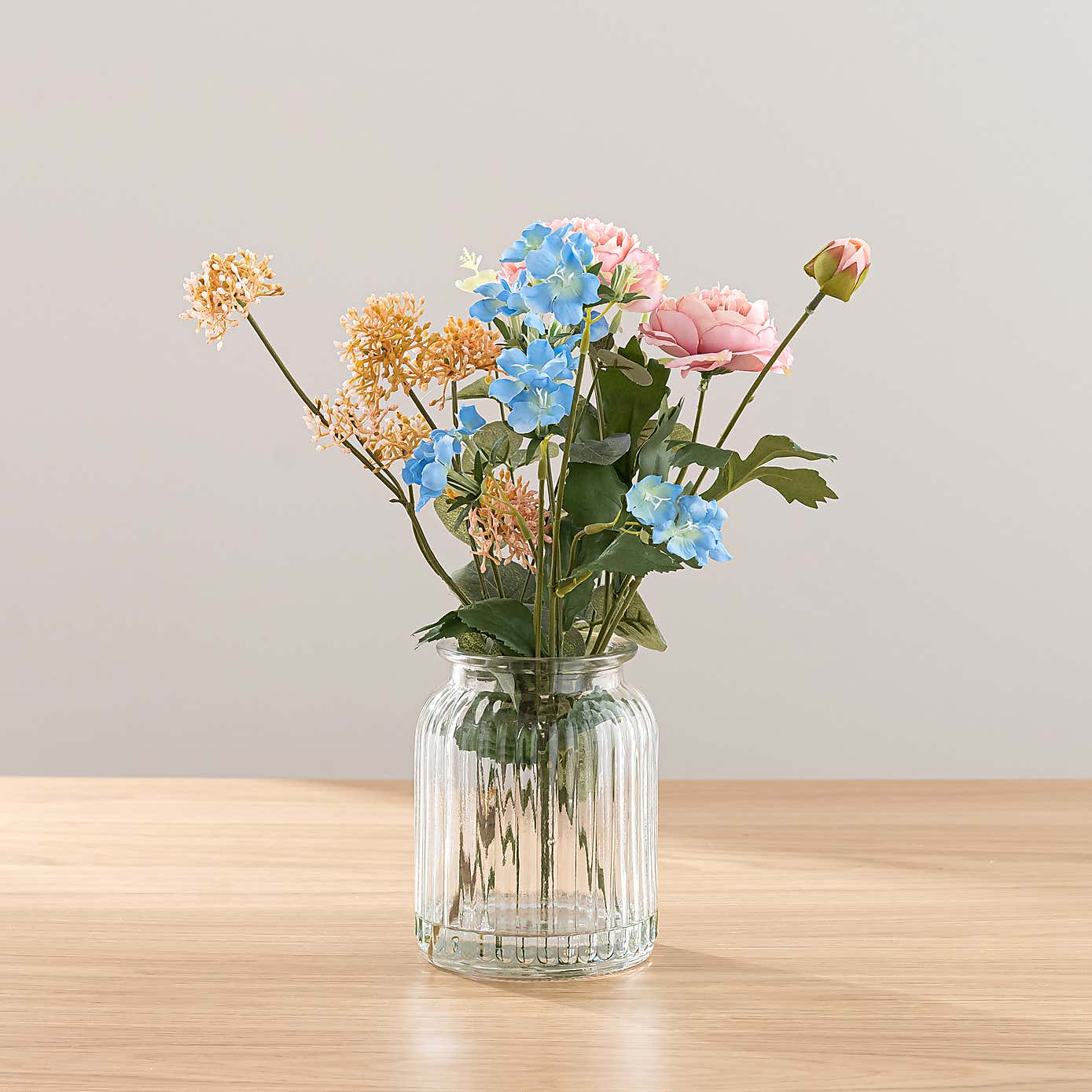 Pink Ranunculus Floral Arrangement in Ribbed Glass Vase with Sweet Jasmine Candle