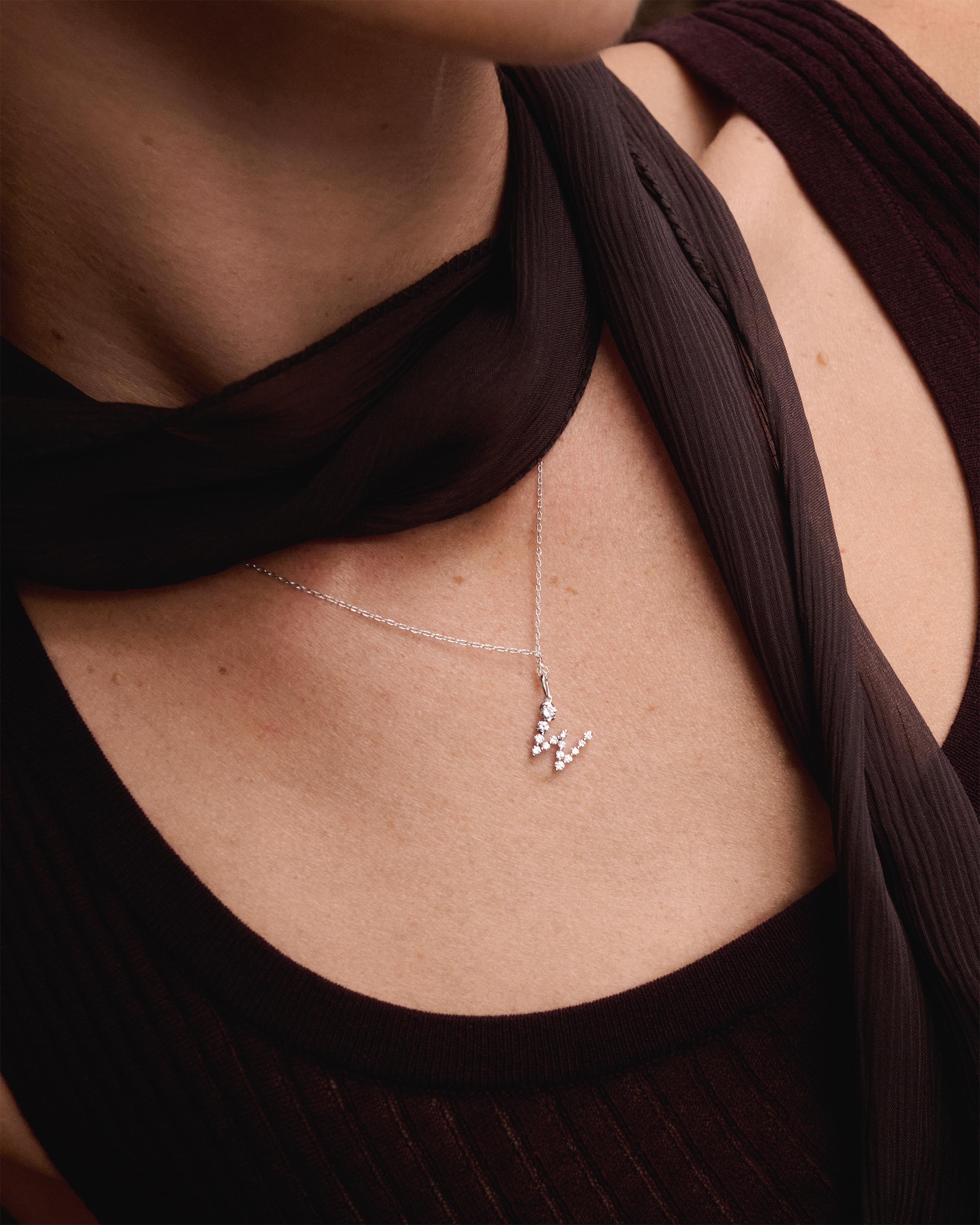 Diamonds and white gold W initial pendant