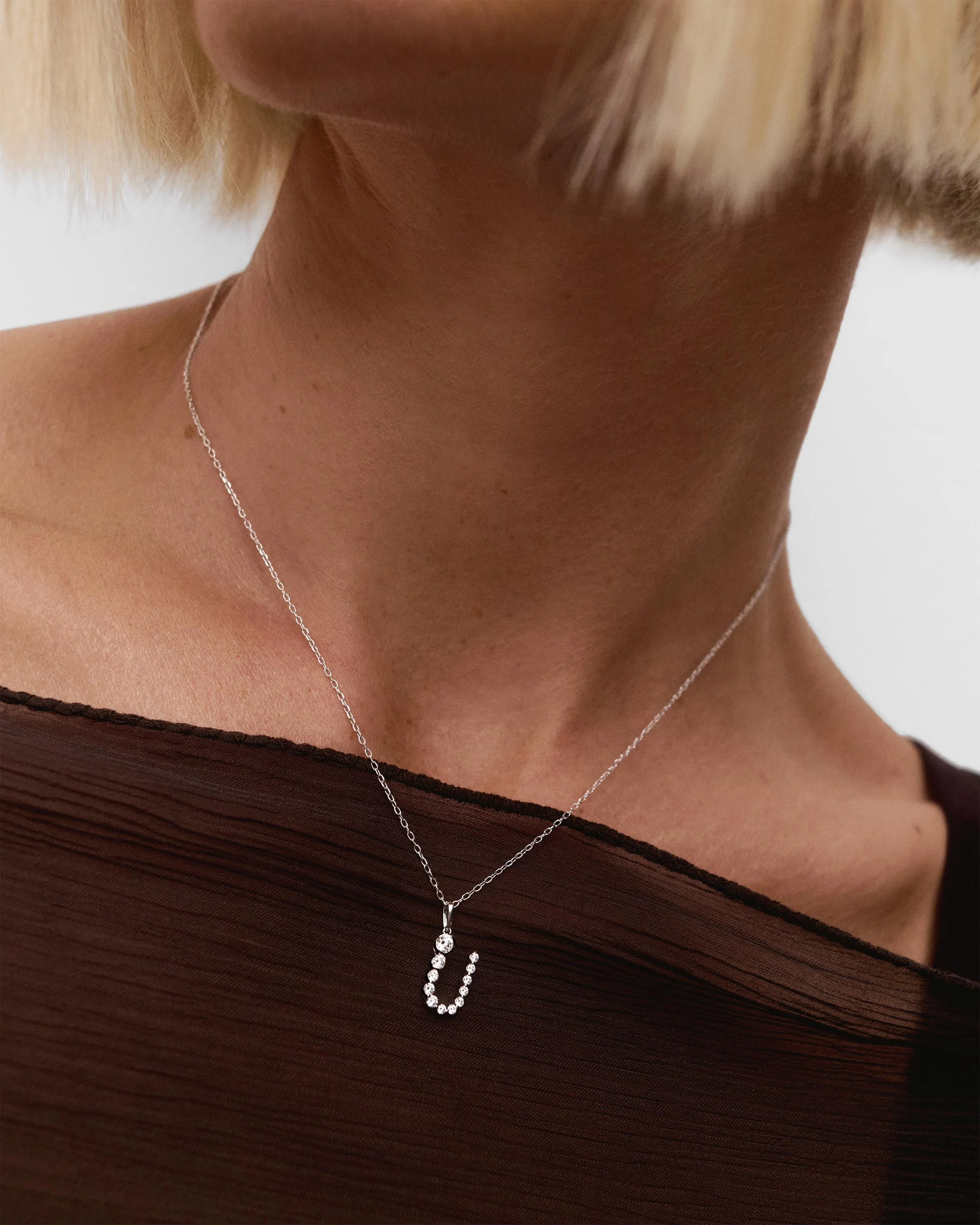 Diamonds and white gold U initial pendant