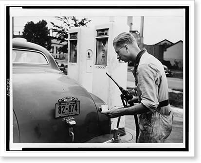 Historic Framed Print, [A Service station attendant measures out gasoline in accordance with the Office of Production Administration's new A gasoline ration books].photo by Liberman., 17-7/8