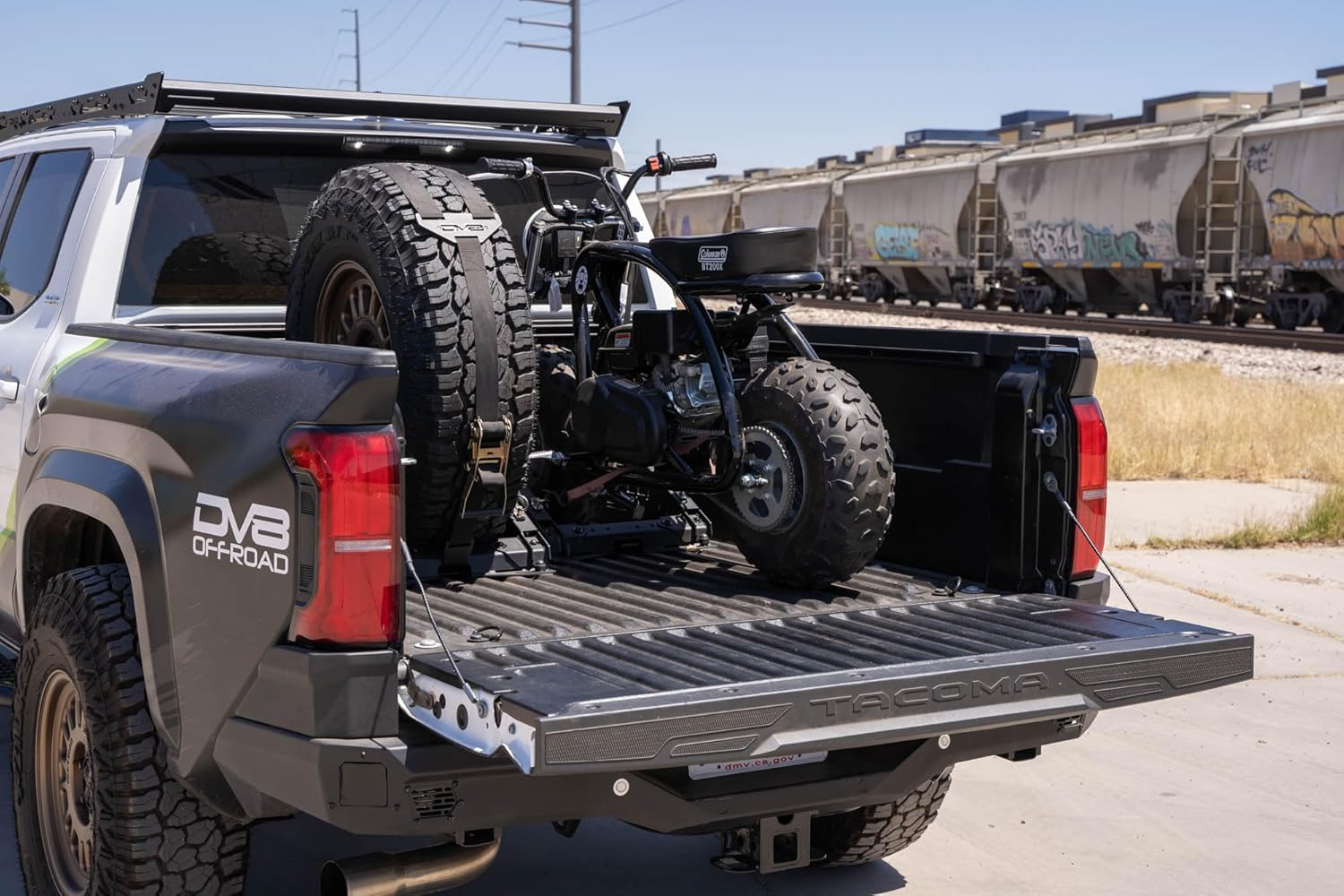 DV8 Offroad Truck Bed Universal Tire Carrier & Accessory Mount | Featured Side Molle Panels for Mounting Gear & Supplies | Adjustable for Carrying Various Sized Tires and Bikes | Powder Coated Finish