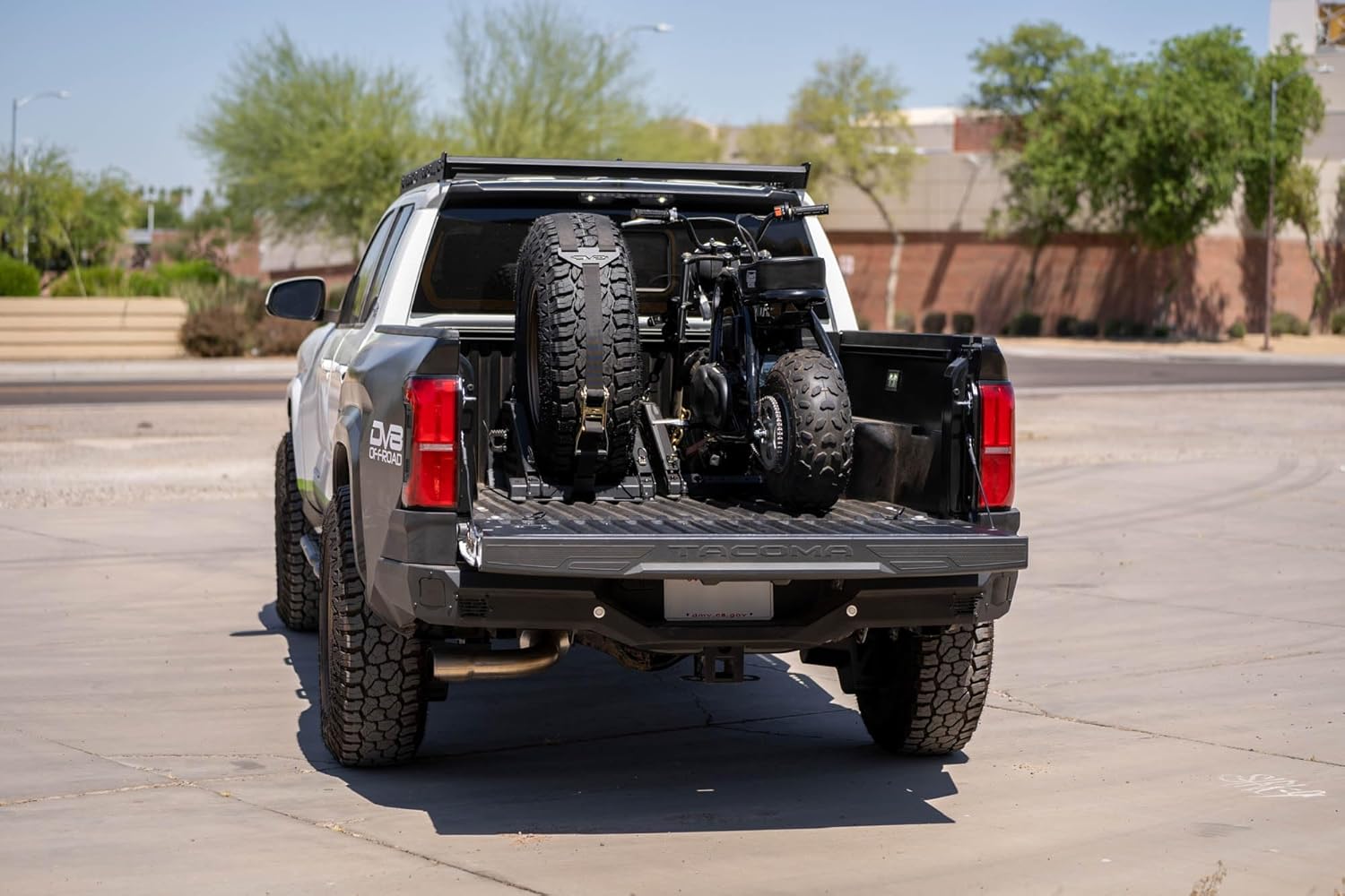 DV8 Offroad Truck Bed Universal Tire Carrier & Accessory Mount | Featured Side Molle Panels for Mounting Gear & Supplies | Adjustable for Carrying Various Sized Tires and Bikes | Powder Coated Finish
